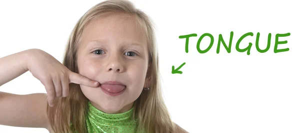 Cute little girl pointing her tongue in body parts learning English words at school — Stock Photo, Image