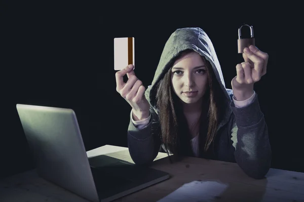 Hacker girl holding credit card violating privacy holding credit card in cybercrime and cyber crime — Stock Photo, Image