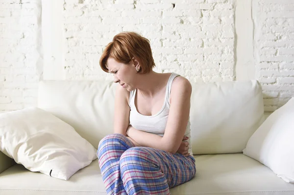 Young woman holding hurting belly suffering stomach cramp period pain — Stock Photo, Image