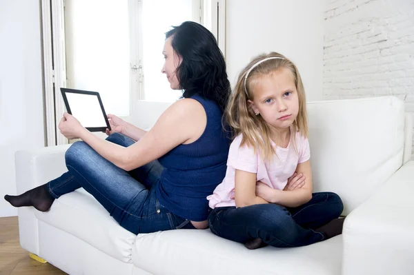 Internet network addict mother using digital tablet pad ignoring little sad daughter left alone bored — Stock Photo, Image