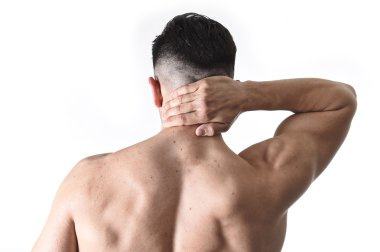young muscular sport man holding sore neck massaging cervical area suffering body pain