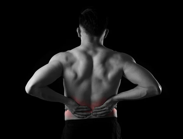 Young muscular body sport man holding sore low back waist are suffering pain in athlete stress — ストック写真