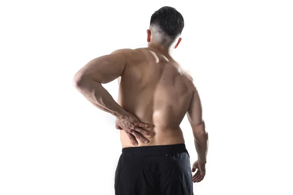 Musculoso cuerpo deporte hombre sosteniendo dolor de espalda baja cintura masaje con su mano sufrimiento dolor — Foto de Stock
