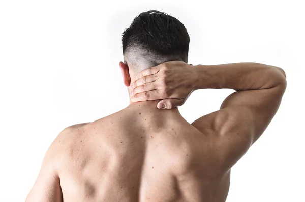 Young muscular sport man holding sore neck massaging cervical area suffering body pain — Stockfoto