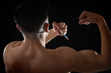 young body building sportsman using steroids for increasing sport and athletic  performance injecting syringe shoulder