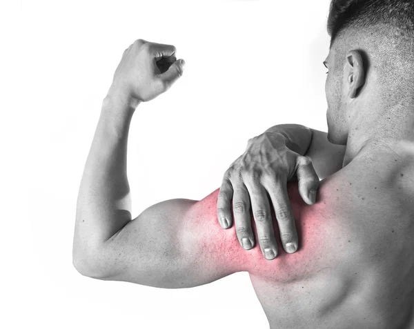 Young muscular sport man holding sore shoulder in pain touching massaging in workout stress — 图库照片