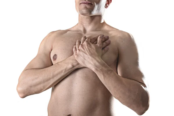 Young strong body sport man with hands on his torso covering his heart in chest pain — Stok fotoğraf