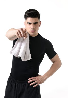young attractive sport man with fit strong body giving holding towel on his shoulder pointing finger