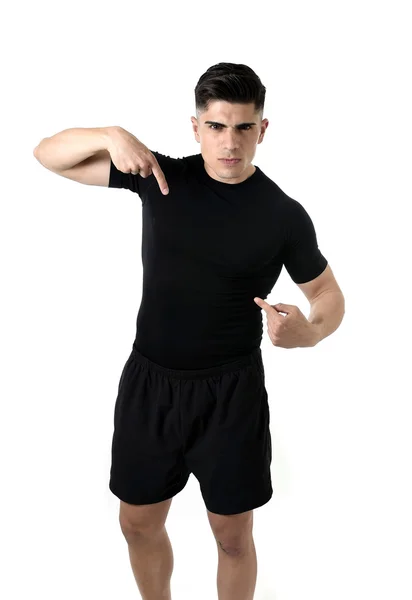 Attractive sport man pointing on his black t-shirt with  copy space for adding gym fitness health club logo — Stock Photo, Image