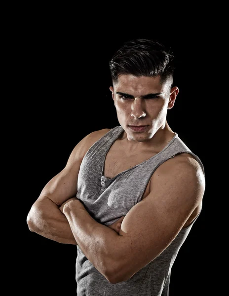 Young attractive sport man with big and strong athletic body posing with folded arms — Stockfoto