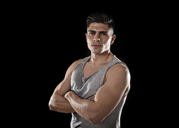 Young attractive sport man with big and strong athletic body posing with folded arms — Stockfoto