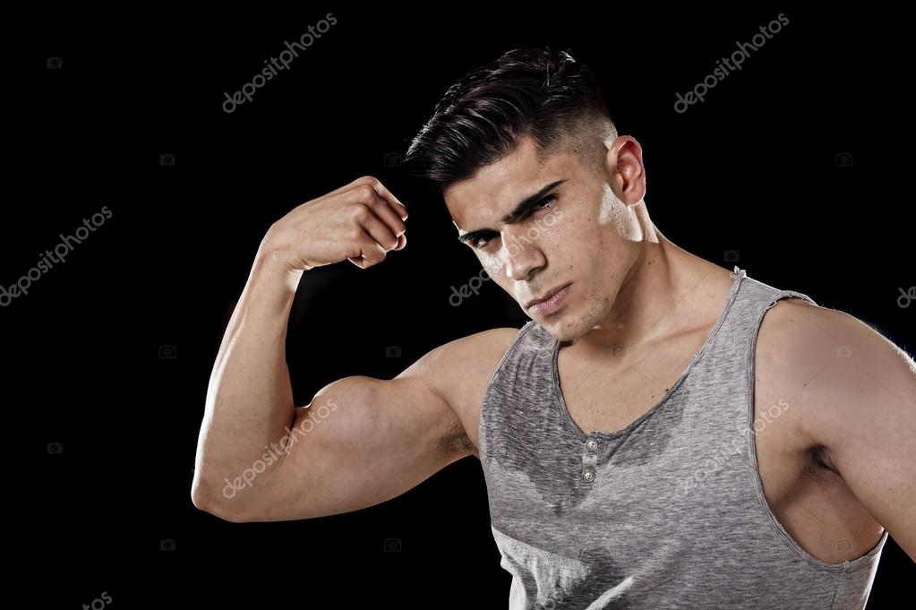 Sport man with big and strong athletic body posing with arm bent