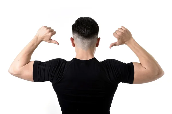 Attractive sport man pointing on his black t-shirt with  copy sp — Stock Photo, Image