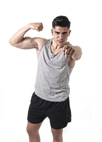 Attractive sport man with big and strong athletic body in singlet pointing to the camera showing biceps — Stock Photo, Image