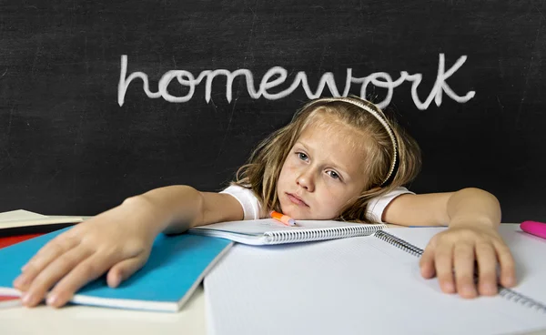 Tired cute junior schoolgirl with blond hair sitting in stress w — Stock Photo, Image