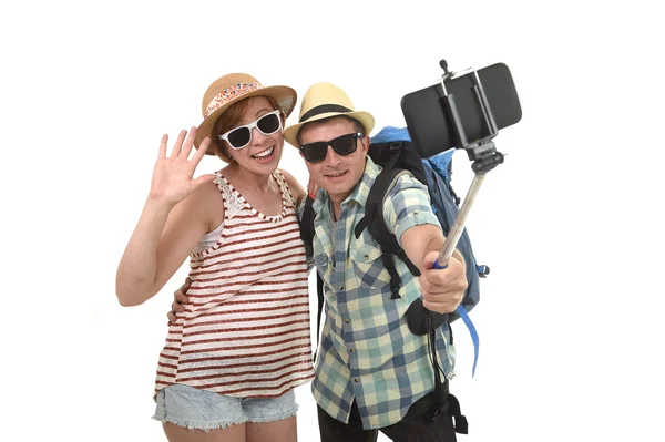 Young attractive and chic American couple taking selfie photo with mobile phone isolated on white — Stock Photo, Image