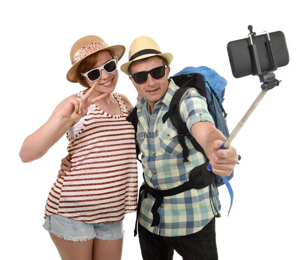 Young attractive and chic American couple taking selfie photo with mobile phone isolated on white — Stock Photo, Image