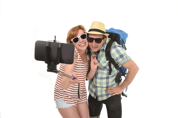 Young attractive and chic American couple taking selfie photo with mobile phone isolated on white — Stock Photo, Image