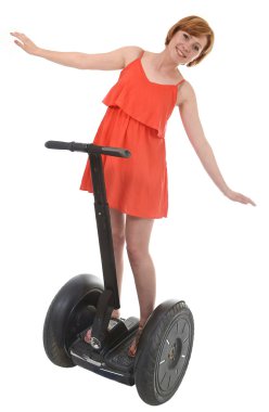 young attractive tourist woman in chic summer dress smiling happy hands free riding electrical segway