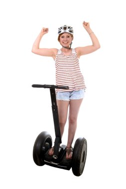 young tourist woman wearing safety helmet rising arms up hands free smiling happy riding electrical segway