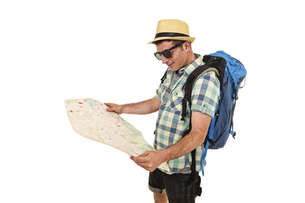 Young tourist man reading city map looking relaxed and happy carrying backpack wearing summer hat — Stock Fotó