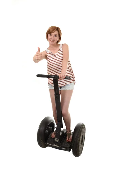 Young attractive tourist woman in summer shorts smiling happy riding electrical segway — 图库照片