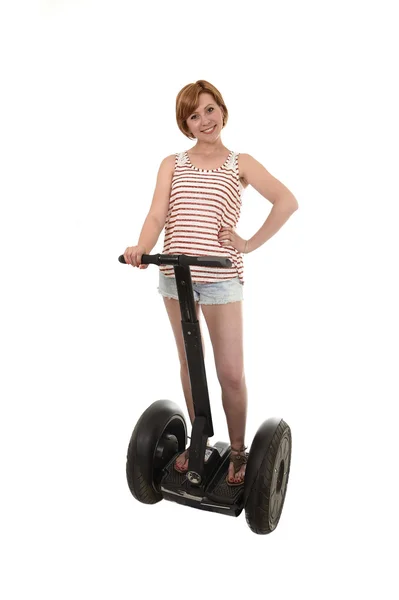 Young attractive tourist woman in summer shorts smiling happy riding electrical segway — Stock Fotó