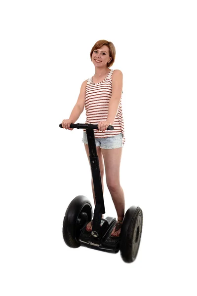 Young attractive tourist woman in summer shorts smiling happy riding electrical segway — Stok fotoğraf