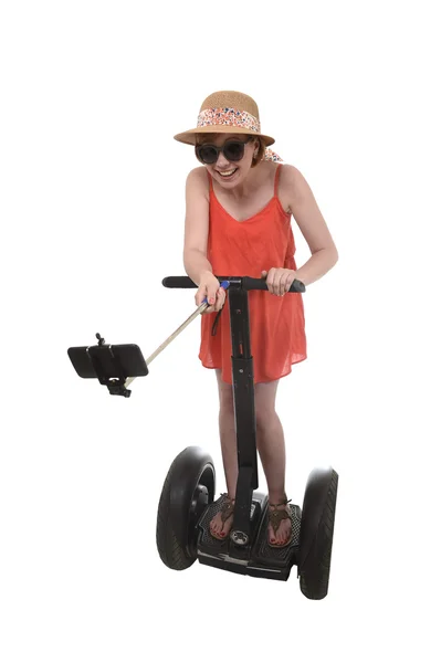 Young chic tourist woman taking selfie photo with mobile phone while riding on segway — Stock Photo, Image