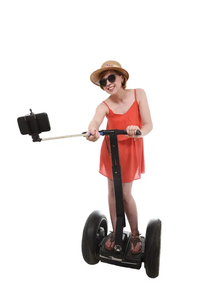 Young chic tourist woman taking selfie photo with mobile phone while riding on segway — Stock Photo, Image