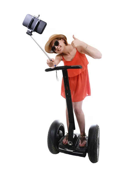 Young chic tourist woman taking selfie photo with mobile phone while riding on segway — ストック写真
