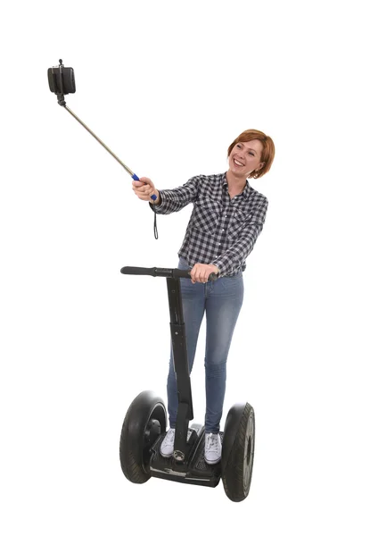 Tourist girl taking selfie photo with mobile phone while riding on segway — Stock Photo, Image