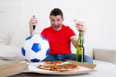 young man holding mobile phone and money in his hands watching fottball game on television internet gambling concept