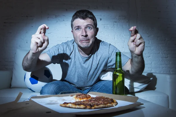 Uomo guardando il calcio in tv nervoso ed eccitato soffre di stress incrociando le dita per gol — Foto Stock