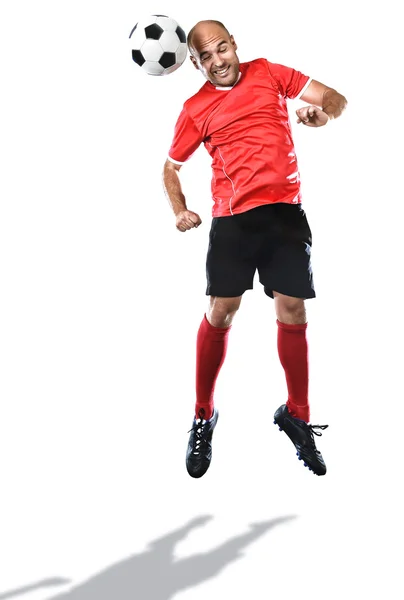 Jugador de fútbol en acción saltando para la patada en la cabeza aislado fondo blanco — Foto de Stock