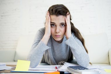 young worried woman suffering stress doing domestic accounting paperwork bills