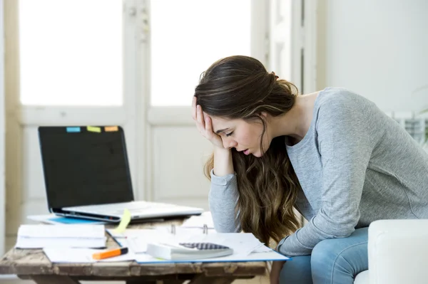 Worried woman suffering stress doing domestic accounting paperwork bills and invoices — Stock fotografie