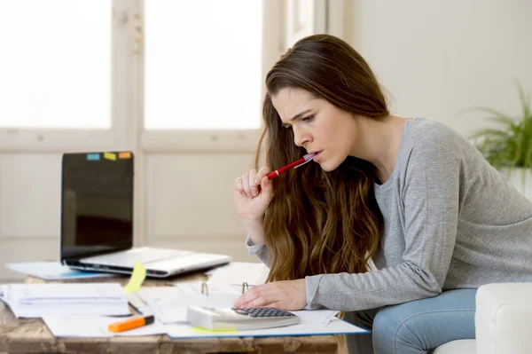 Worried woman suffering stress doing domestic accounting paperwork bills and invoices — ストック写真