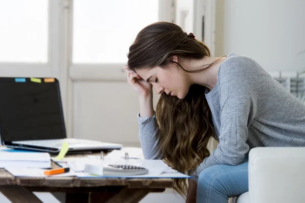 Worried woman suffering stress doing domestic accounting paperwork bills and invoices — Stock fotografie