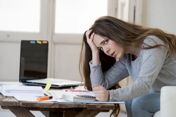 Worried woman suffering stress doing domestic accounting paperwork bills and invoices — Stock fotografie