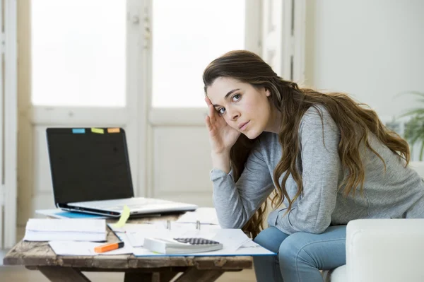 Worried woman suffering stress doing domestic accounting paperwork bills and invoices — Stock fotografie