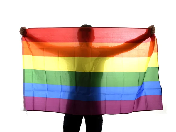 Junge stolze homosexuelle Mann Verbreitung breit großen Stolz homosexuelle Flagge mit seinem Schatten hinter dem Tuch — Stockfoto