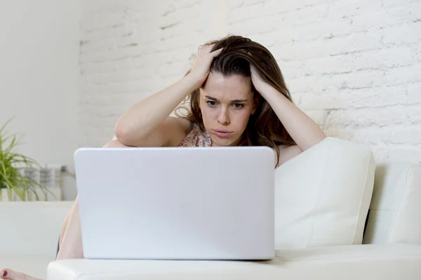 Besviken tjej hemma soffa använder internet för att studera med bärbar dator — Stockfoto