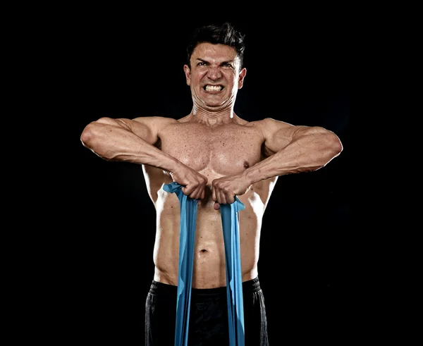 Strong fit sport man training hard with elastic rubber band working muscles sweating — Stock Photo, Image