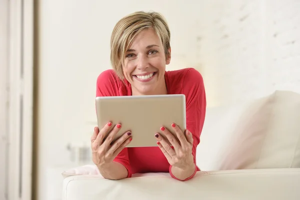 Young beautiful happy 30s woman smiling using digital tablet pad at home living room couch — Stok fotoğraf