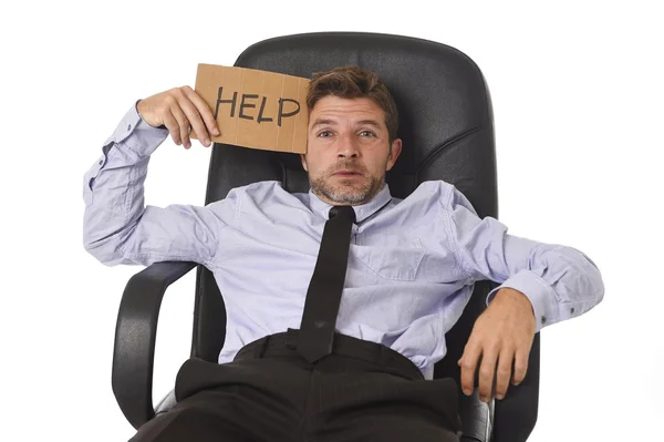 Young attractive tired and wasted businessman sitting on office chair asking for help in stress — Zdjęcie stockowe