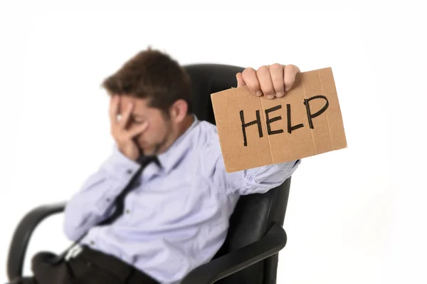 Young attractive tired and wasted businessman sitting on office chair asking for help in stress — Stock fotografie