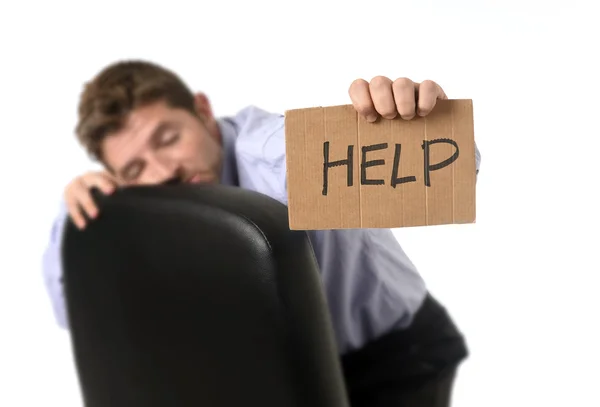 Young attractive tired and wasted businessman sitting on office chair asking for help in stress — Stok fotoğraf
