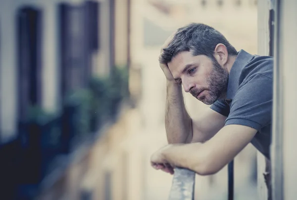 Young man at balcony in depression suffering emotional crisis — Stock Photo, Image