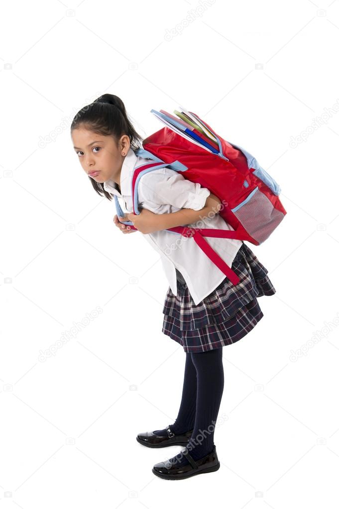 Sweet little girl carrying very heavy backpack or schoolbag full Stock